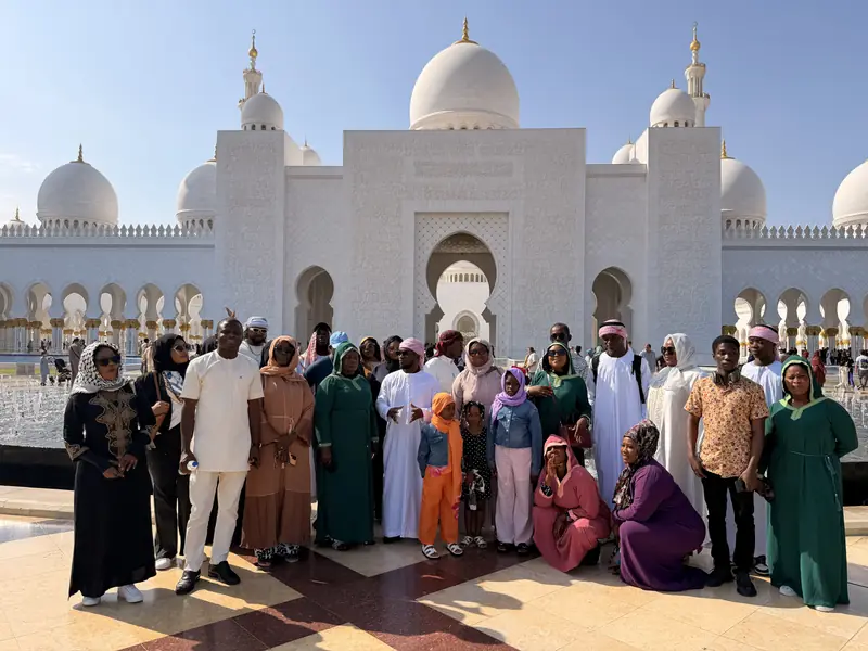 The group gathered in the mosque courtyard beneath its white domes