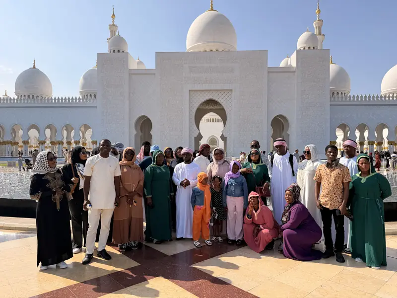 The group posing in front of the main entrance of the Sheikh Zayed Grand Mosque