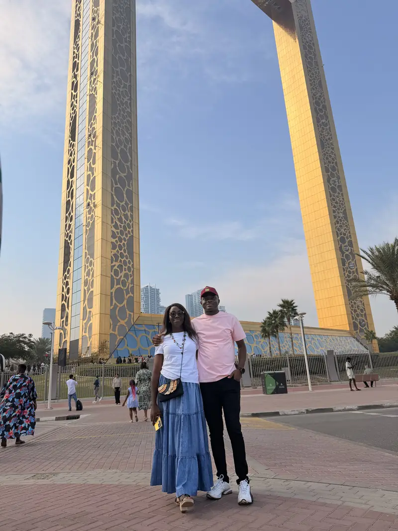 A couple posing together in front of the Dubai Frame