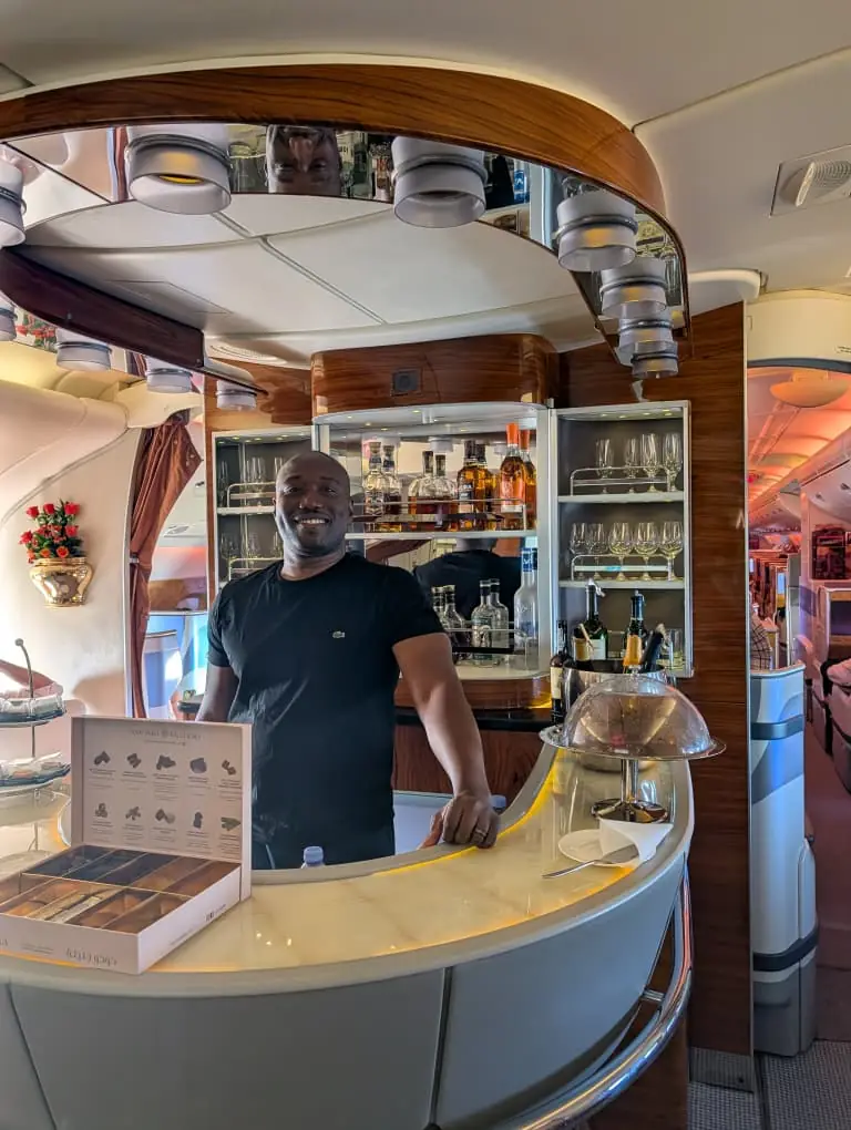 A traveller standing at the curved bar of an aircraft onboard lounge