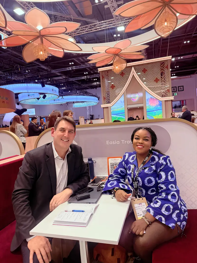 A Myma Travels team member in a business meeting with a partner at a trade fair